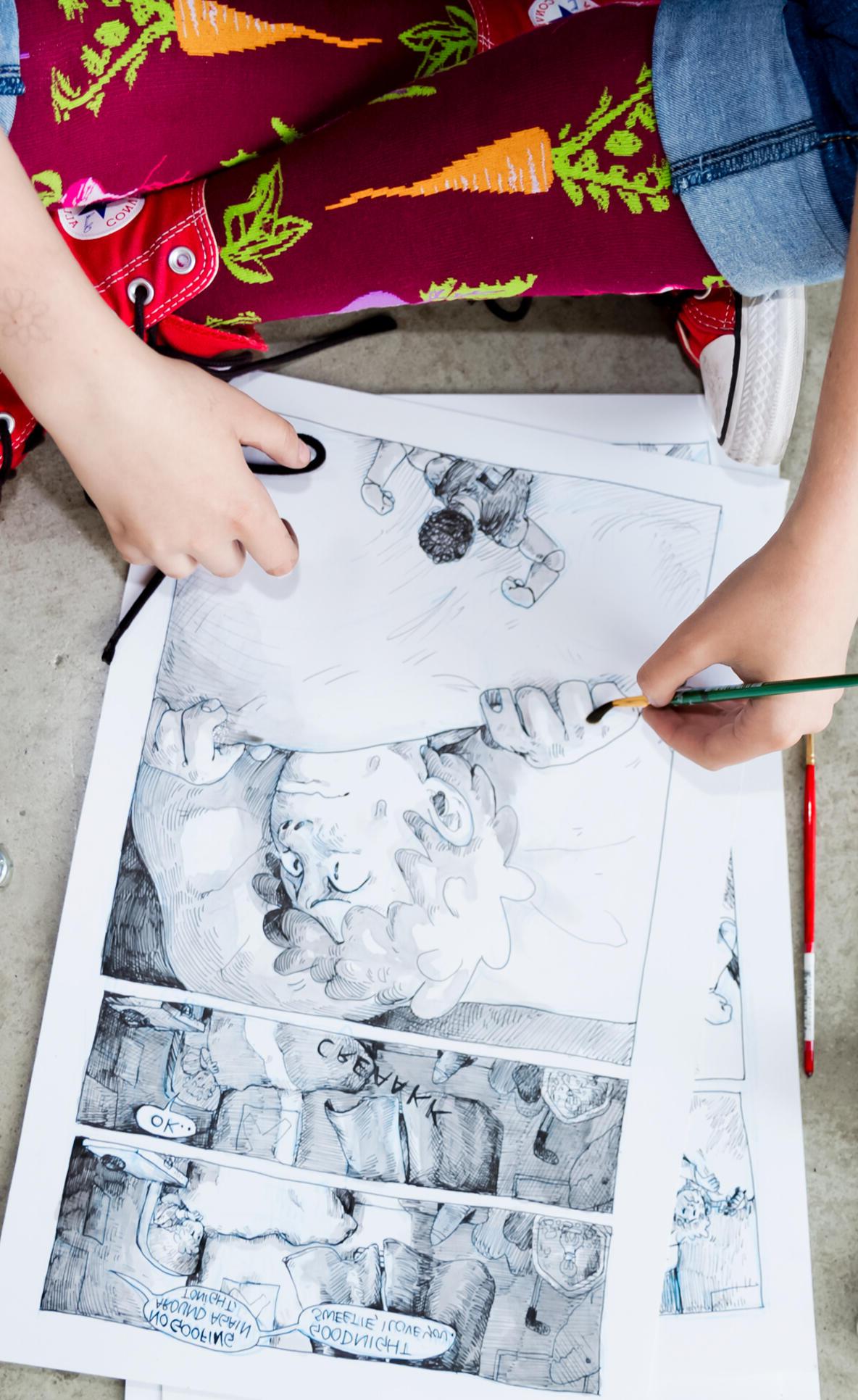 Overview shot of a student painting a comic