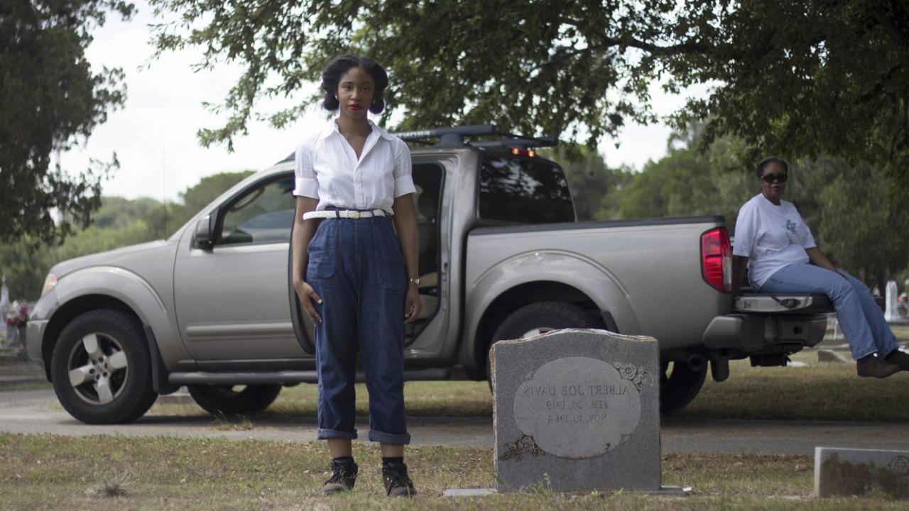 Candice Davis standing by a gravestone
